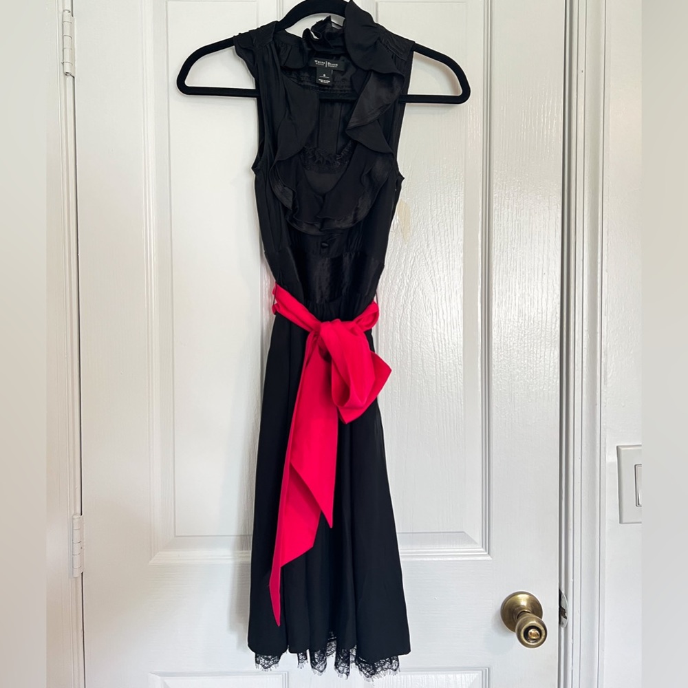 White House black dress is lace trim and pink fabric belt